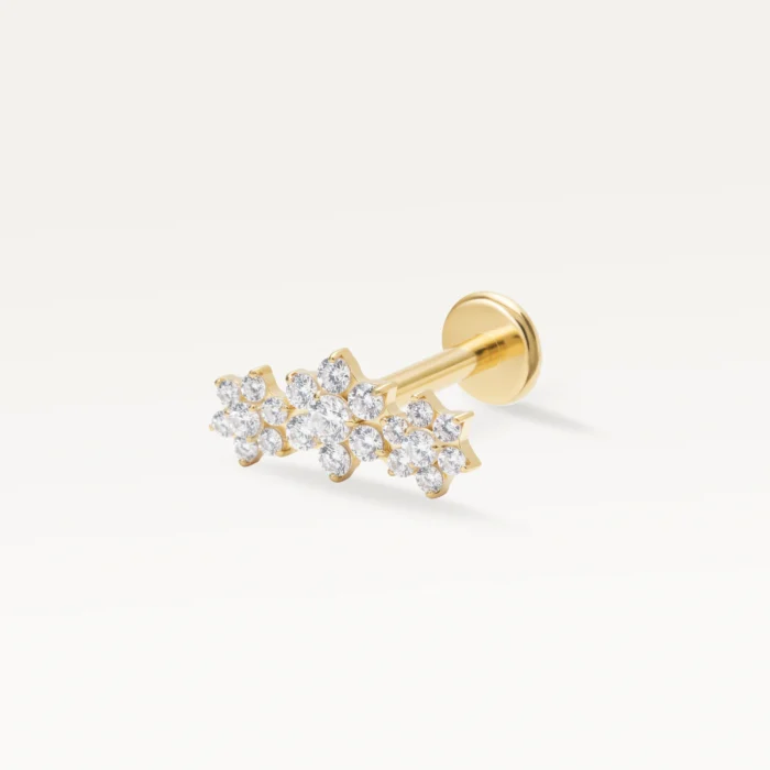 Piercing doré motif constellation florale serti de multiples zircons scintillants