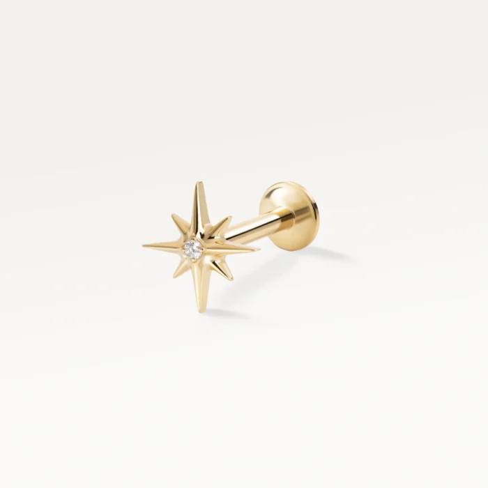 Piercing labret doré en forme d’étoile à huit branches, orné d’un zircon central