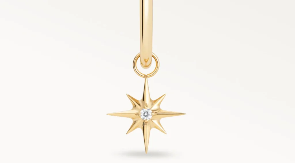 Piercing anneau doré avec pendentif étoile et zircon central, vue en gros plan détaillée