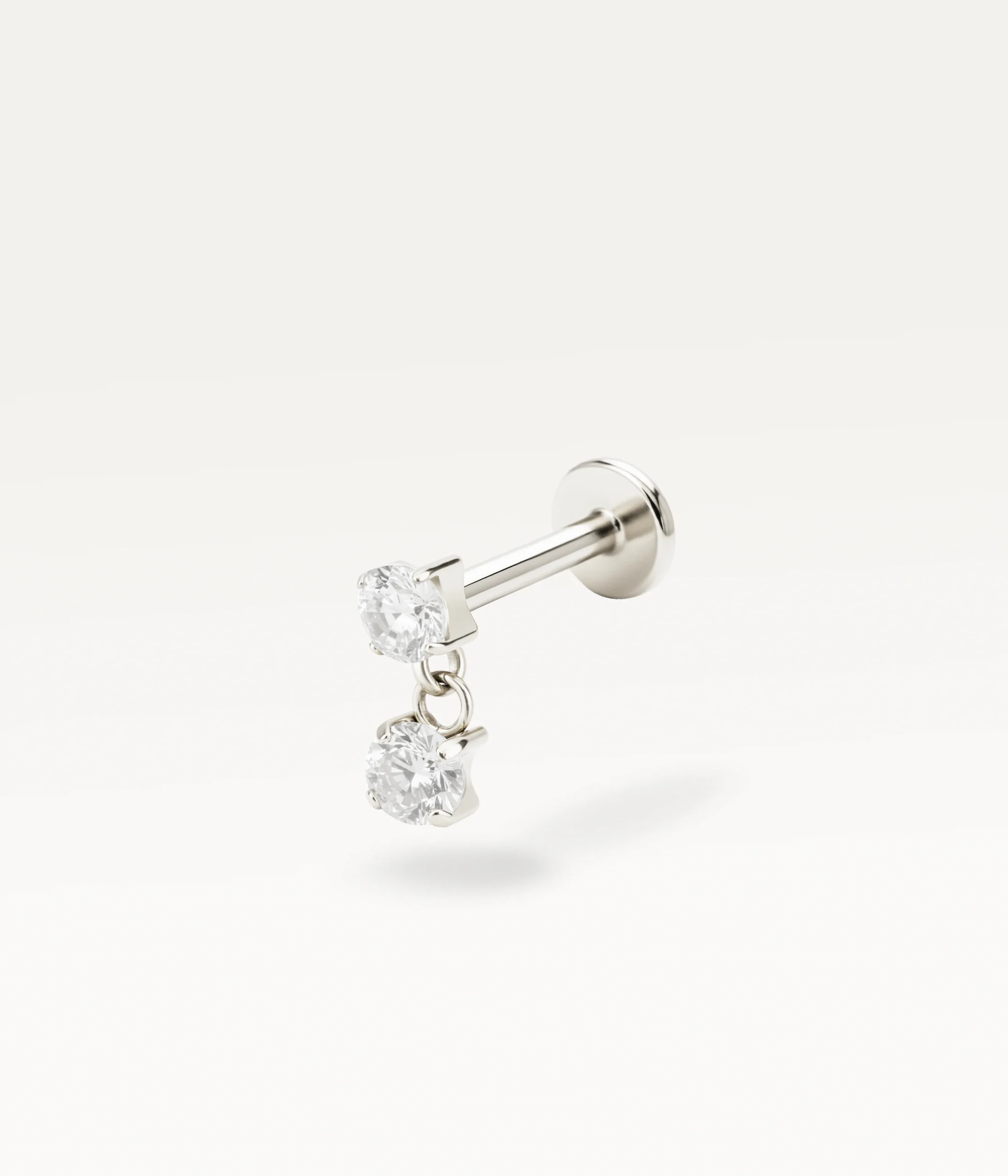 Piercing puce argenté orné de deux pierres lumineuses suspendues